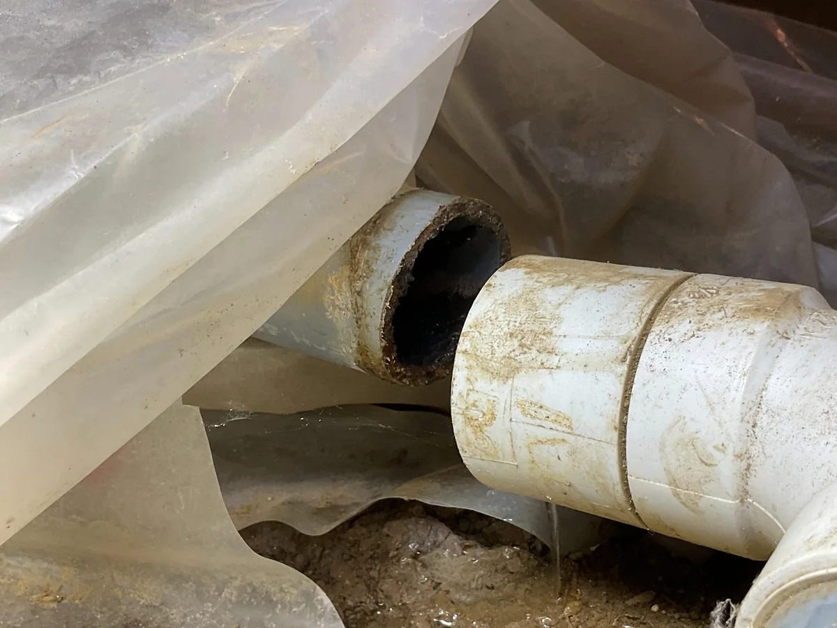 Disconnected drain piping in a crawlspace