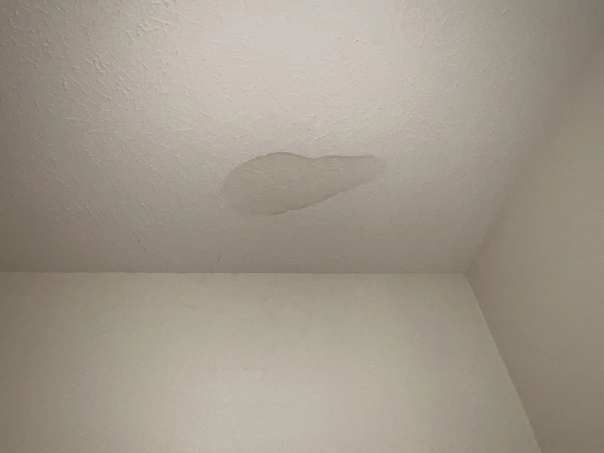Discolored area on a ceiling consistent with moisture staining
