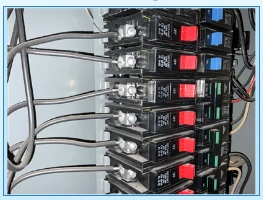 Small aluminum branch-circuit conductors connected to breakers inside an electrical panel